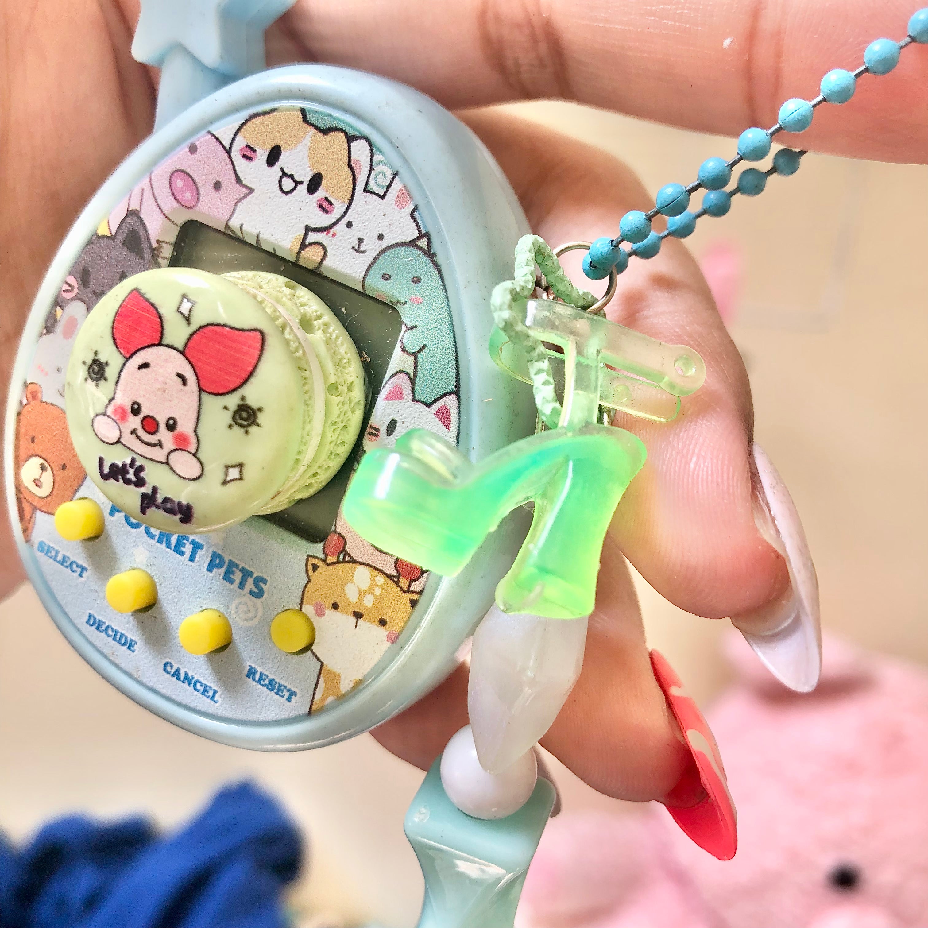 Pocket Pets virtual pet toy back view with beaded chain and green charms