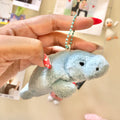 Front face view of Colorata baby blue manatee plush keychain