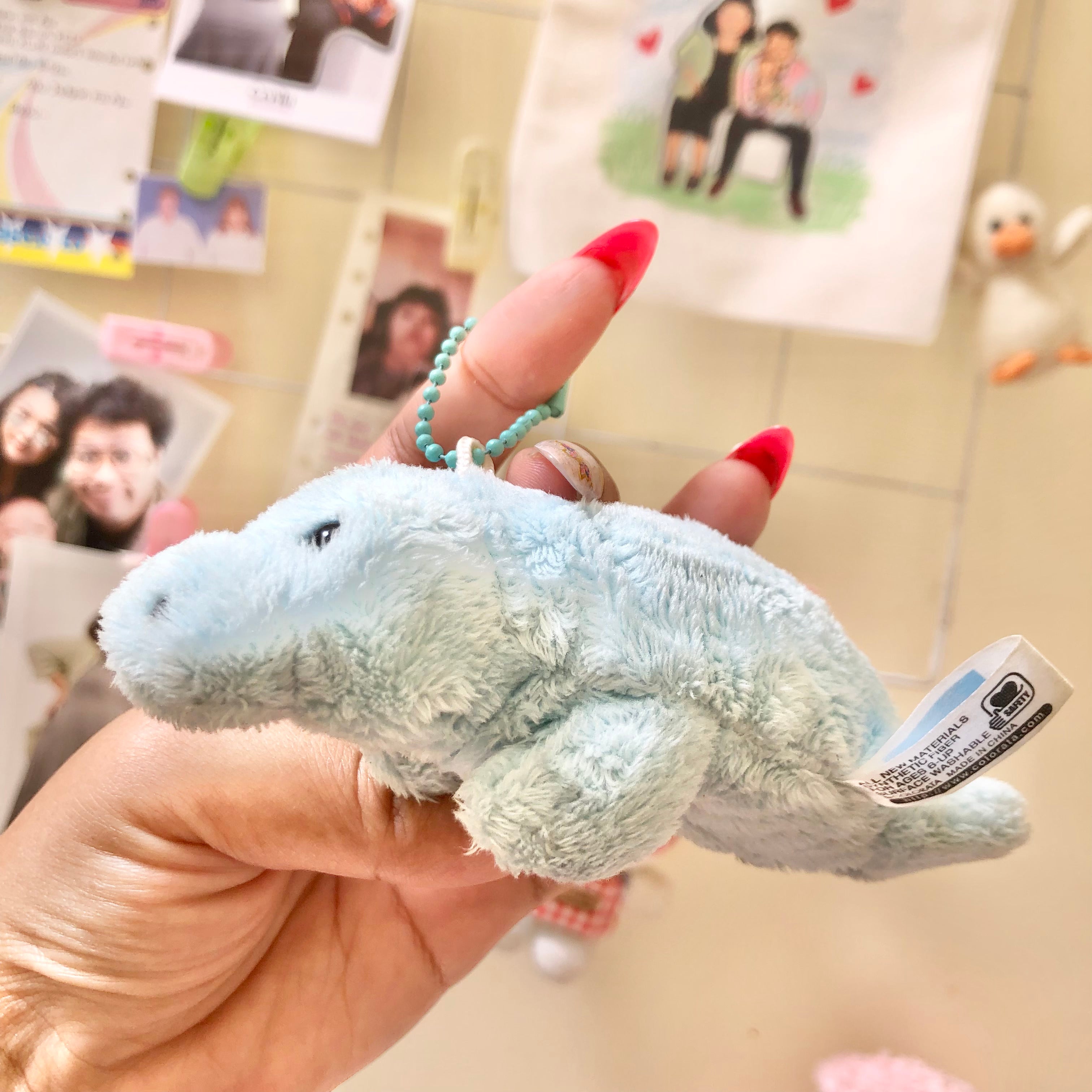 Side view of Colorata manatee plush keychain showing full body